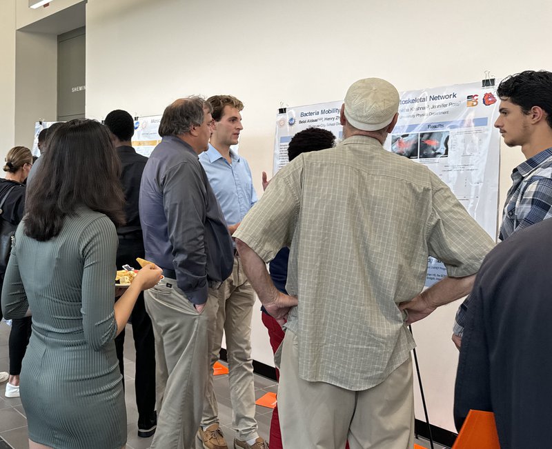 People at a poster presentation.