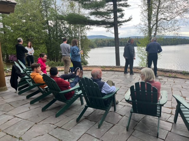 People talking while overlooking a lake.