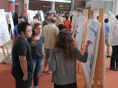 Students present their research in the Milton Atrium of the Life Sciences Complex during the 2016 REU poster session. 