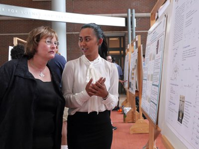 Dean Karin Ruhlandt listens as a 2016 REU student, Kim La, discusses her research project