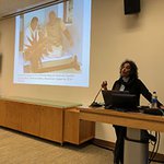 Prof. Sumathi Ramaswamy (Duke University) in front of a projector