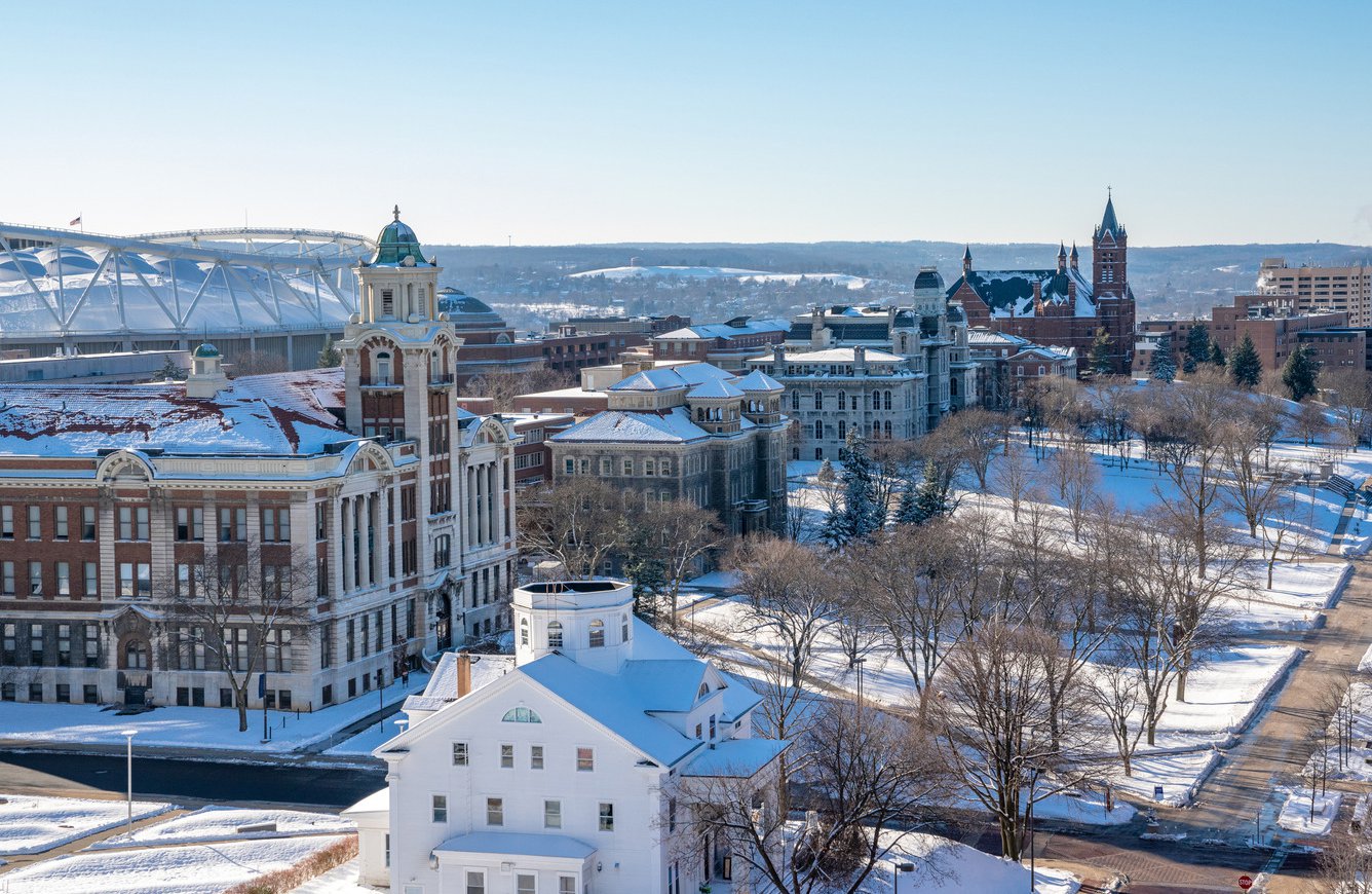 Syracuse Uniniversity campus in winter with snow on the ground.