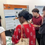 Person giving a poster presentation.