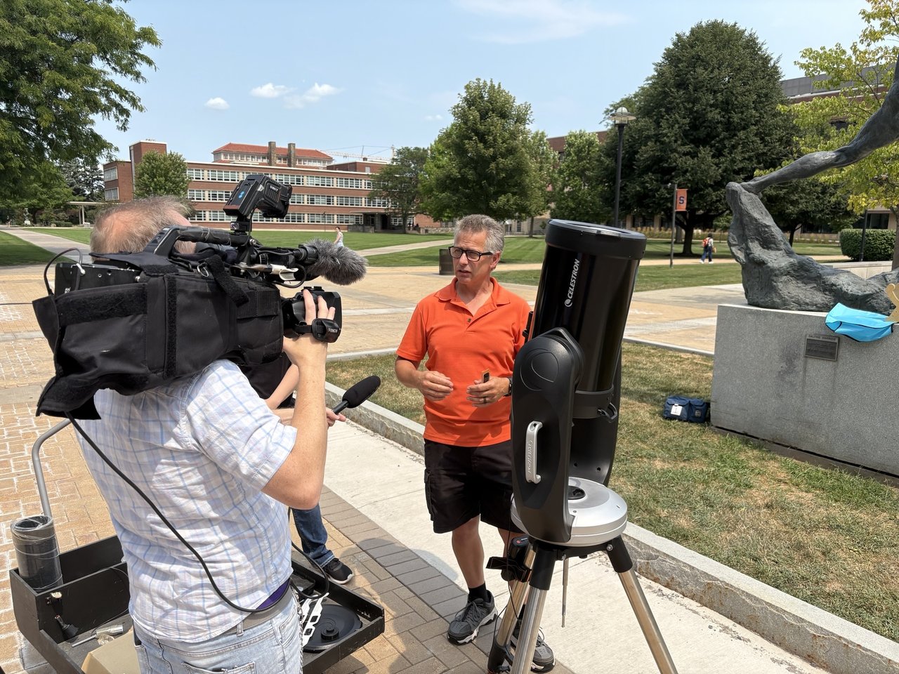 Person being interviewed by a news crew.