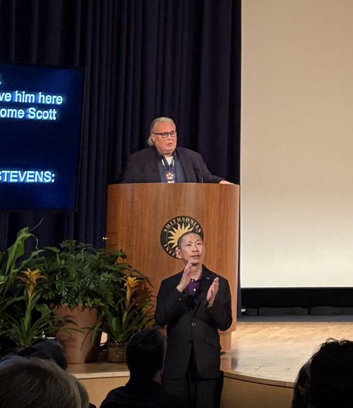 Person speaking at a podium.