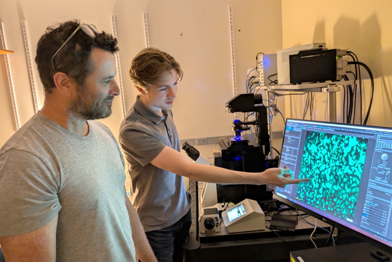 Two people reviewing cellular imaging.