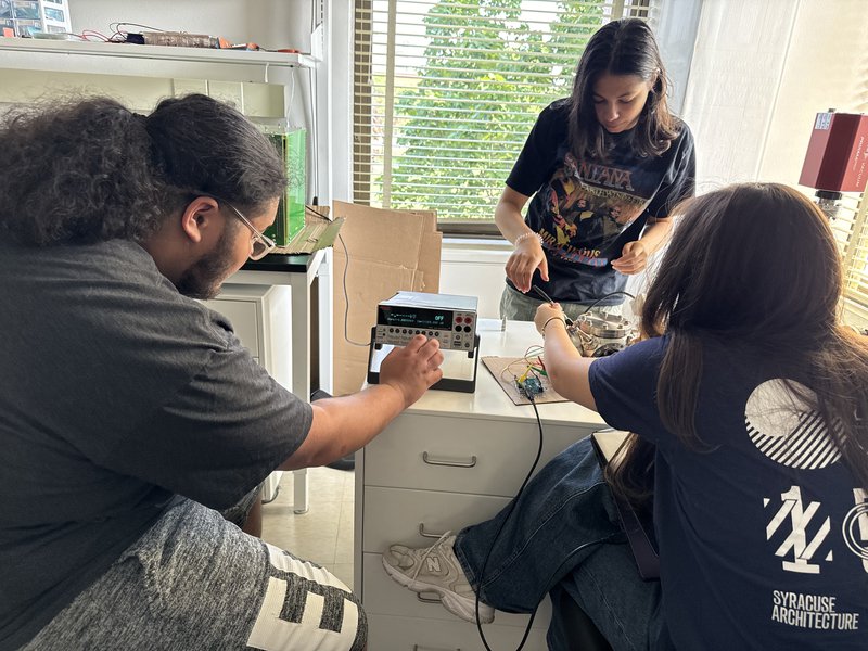 Students tuning a particle detector.