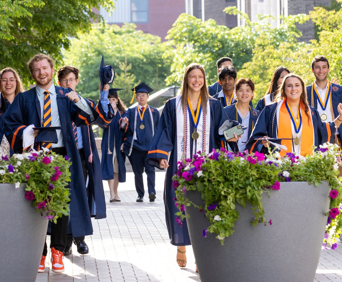 Group of graduates walking on campus.