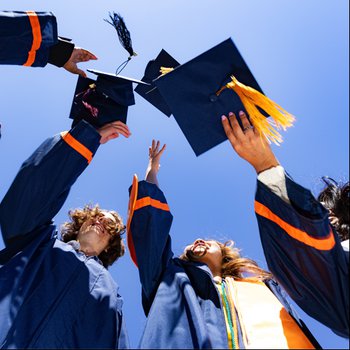 Students throwing caps in the air.