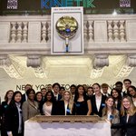 Students with stock exchange bell 2022 Stocks and Finance Immersion