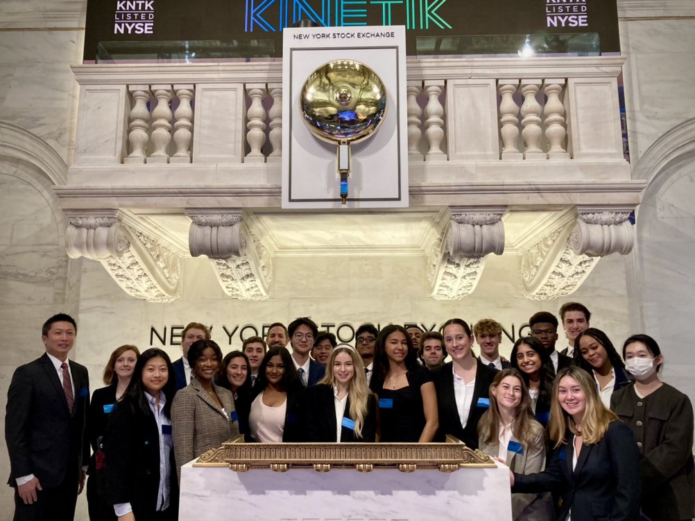 Students with stock exchange bell 2022 Stocks and Finance Immersion