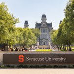 Syracuse University sign in foreground with Hall of Languages in background