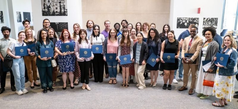 Group of people holding awards.
