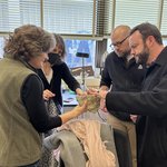 Group of people holding a fossil.
