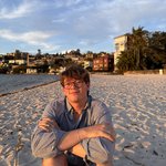 Person sitting on a beach.