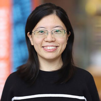 portrait of a woman with black hair and glasses