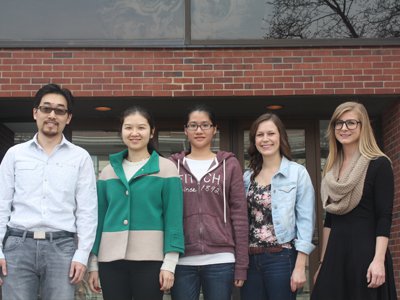 Professor Zunli Lu shown with members of his research lab at Syracuse University. 