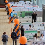 An overhead shot of students displaying their work at a research festival