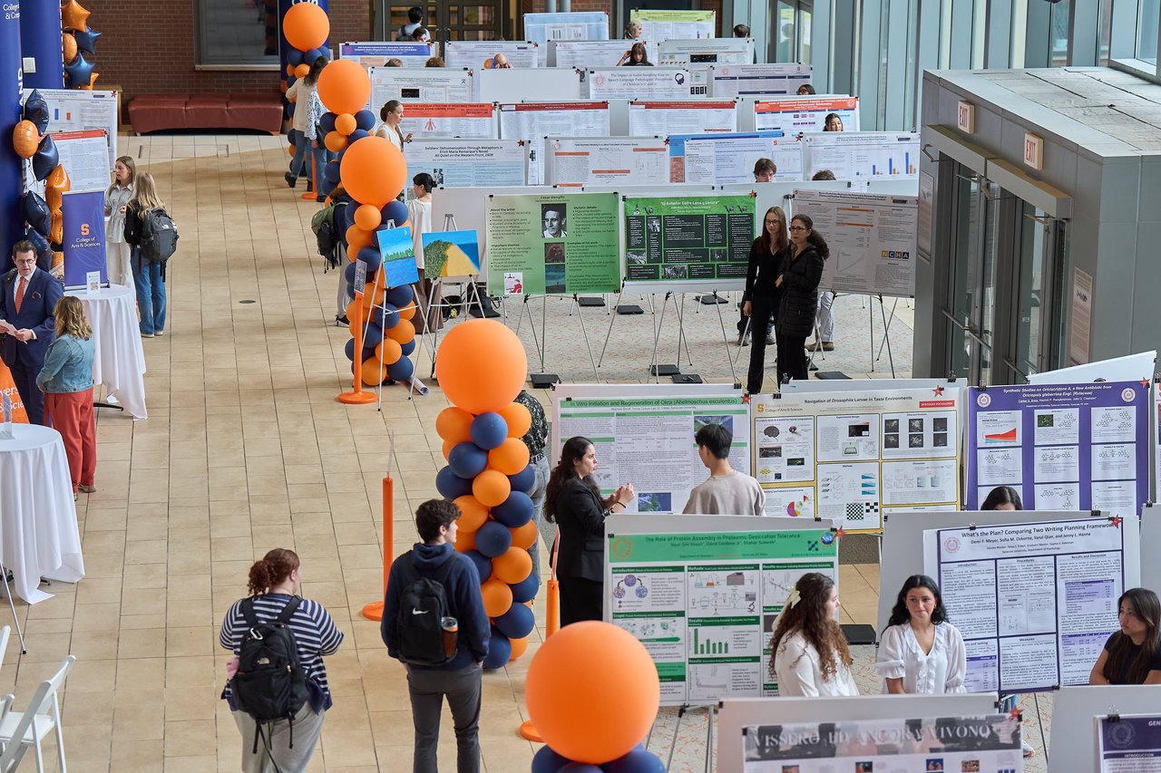 An overhead shot of students displaying their work at a research festival
