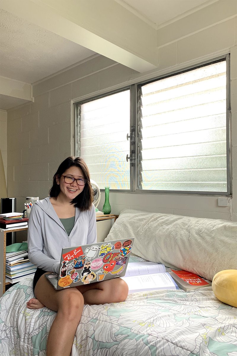 student on bed with laptop