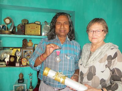 Carol Babiracki and Mukund Nayak, shown holding his 2017 Padma Shri medal. 