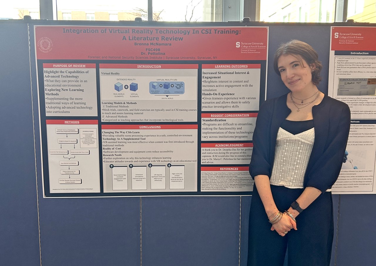 Woman standing with academic poster.