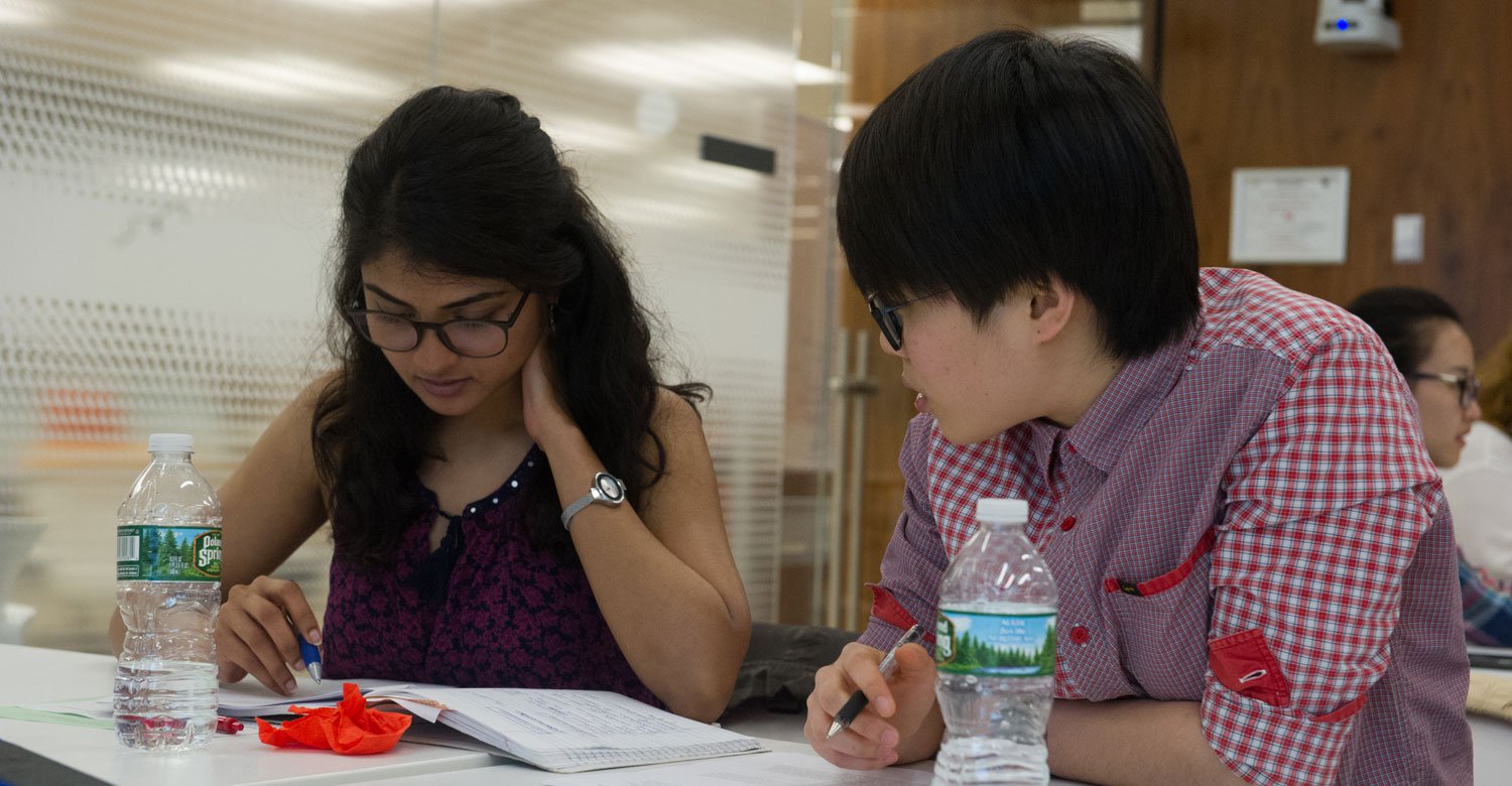 a male and female student discussing writing ideas