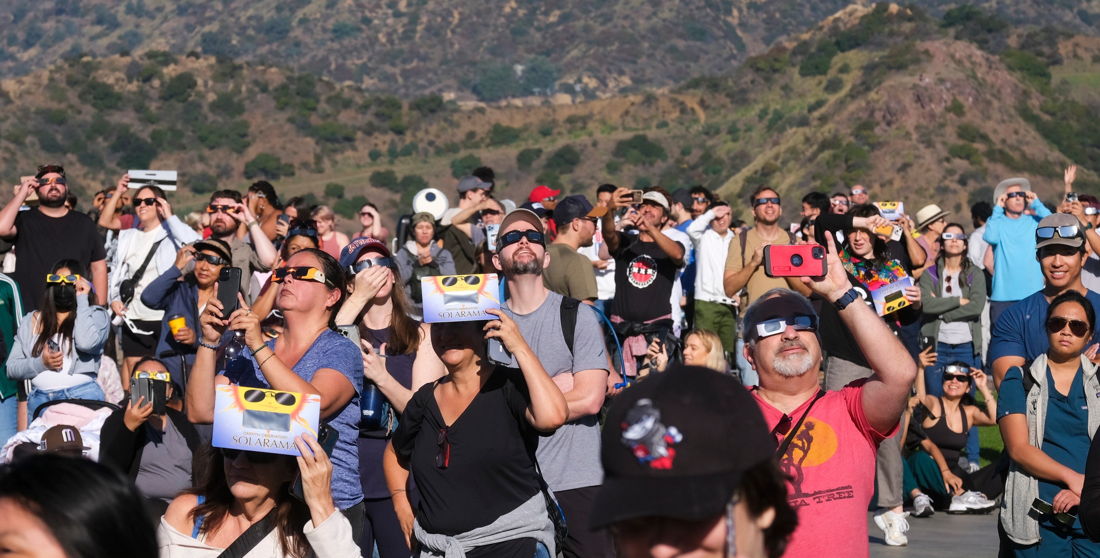 Solar enthusiasts view a partial solar eclipse through special protective glasses at the Griffith Observatory to watch the solar eclipse in Los Angeles Saturday, Oct. 14, 2023.