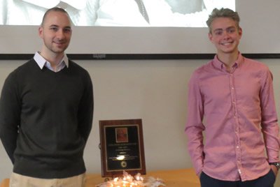 Seniors Luke Chadwick (left) and Emil Hannesbo flank the Sanford Award plaque.