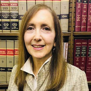 Justice Jaffe in front of law books.