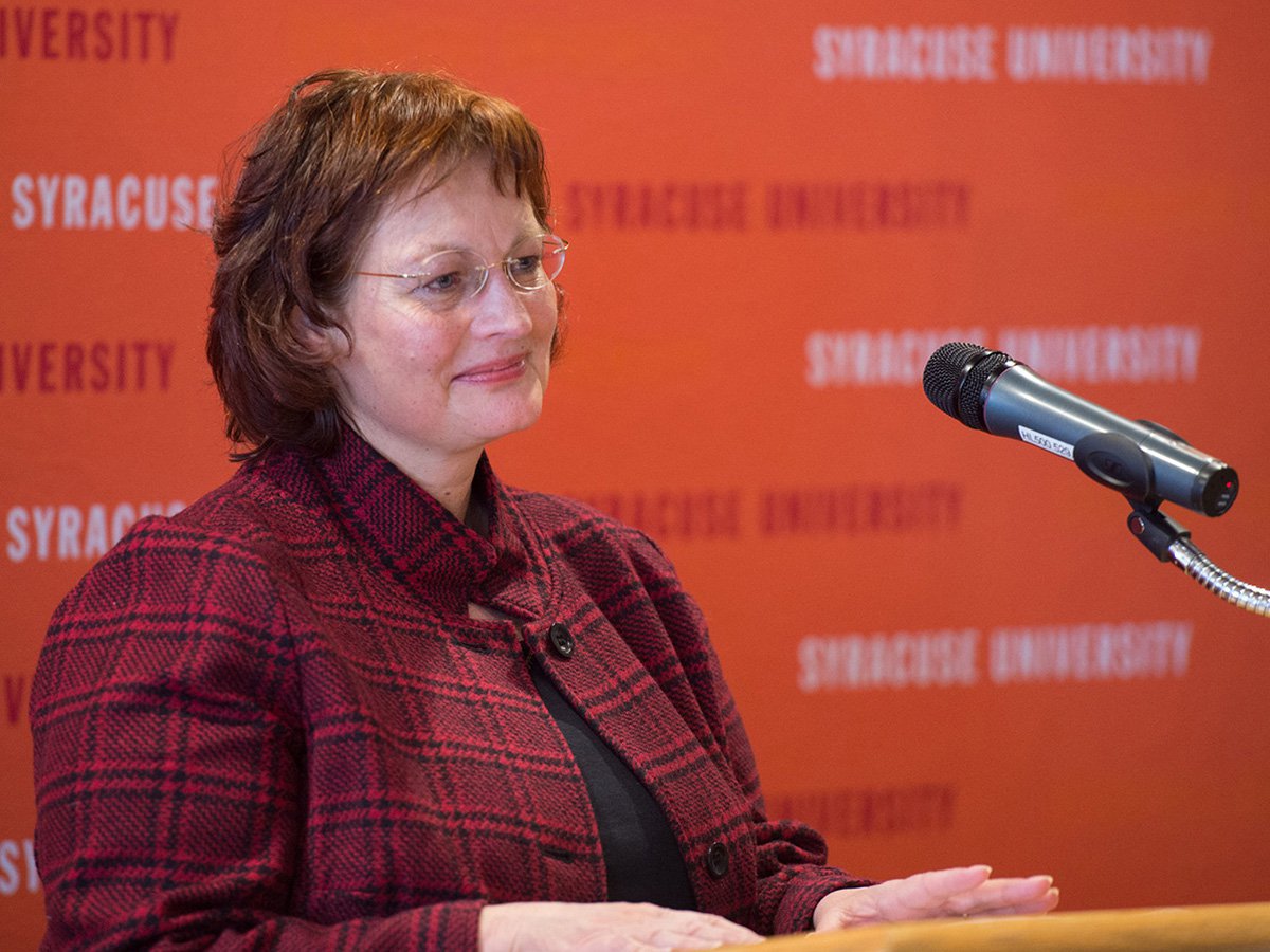 Dean Karin Ruhlandt at a lectern.