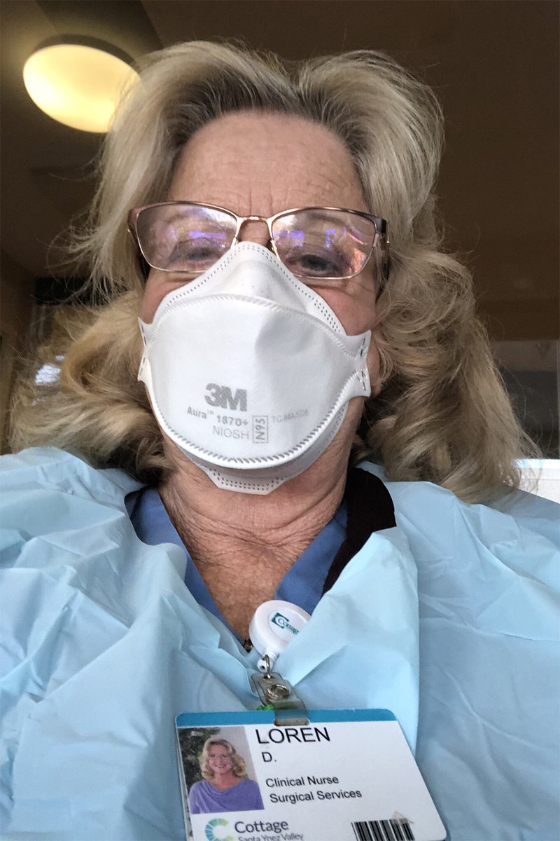 woman wearing scrubs and a mask