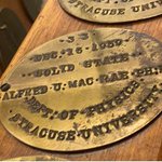 a plaque on mrs. jennings wooden leg with Alfred U. MacRae's PhD plaque