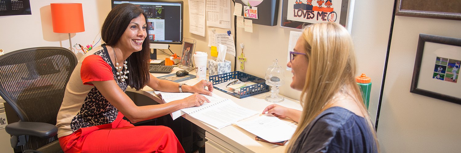 advisor meeting with a student in an office setting