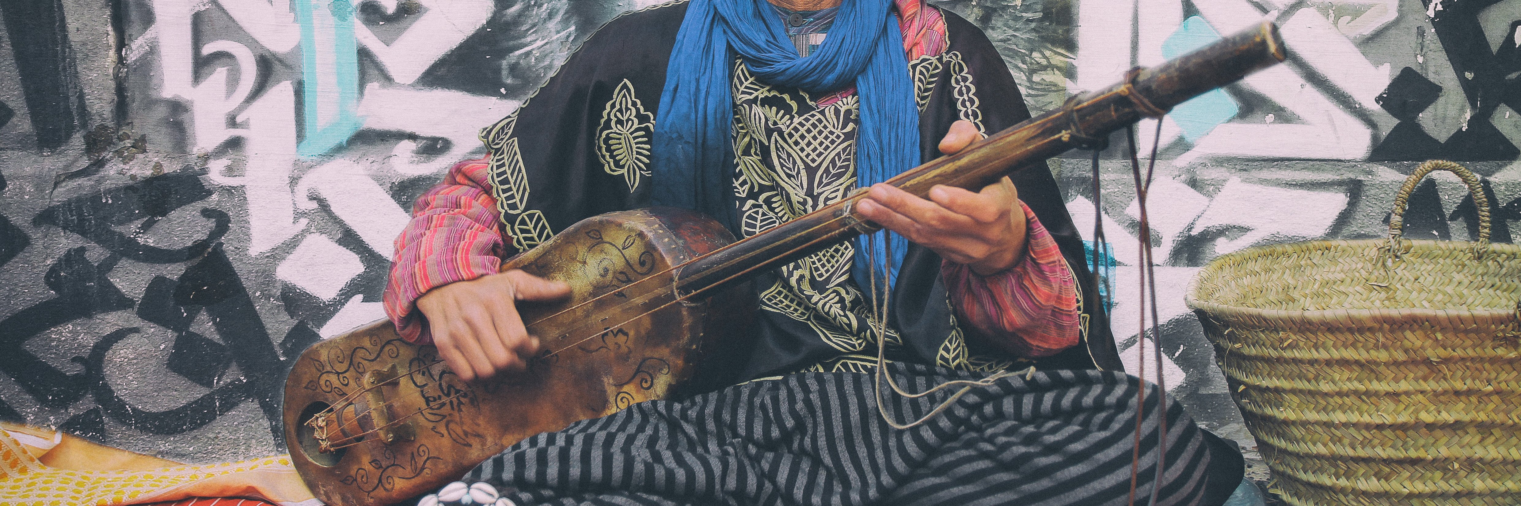 person playing a stringed musical instrument in Asilah, Morocco