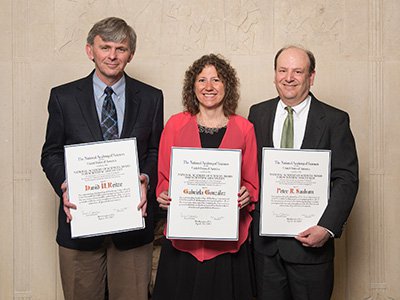 González flanked by David Howard Reitze (left) and Peter Saulson, physics professors at Florida and Syracuse, respectively. All three are former LIGO spokespeople. (Photo courtesy of the National Academy of Sciences)