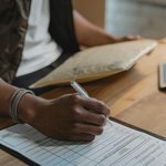 Person filling out a form.