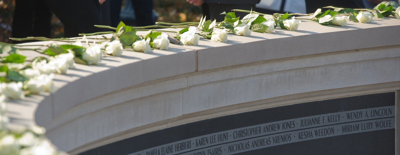 Wall of Remembrance memorial with white roses.