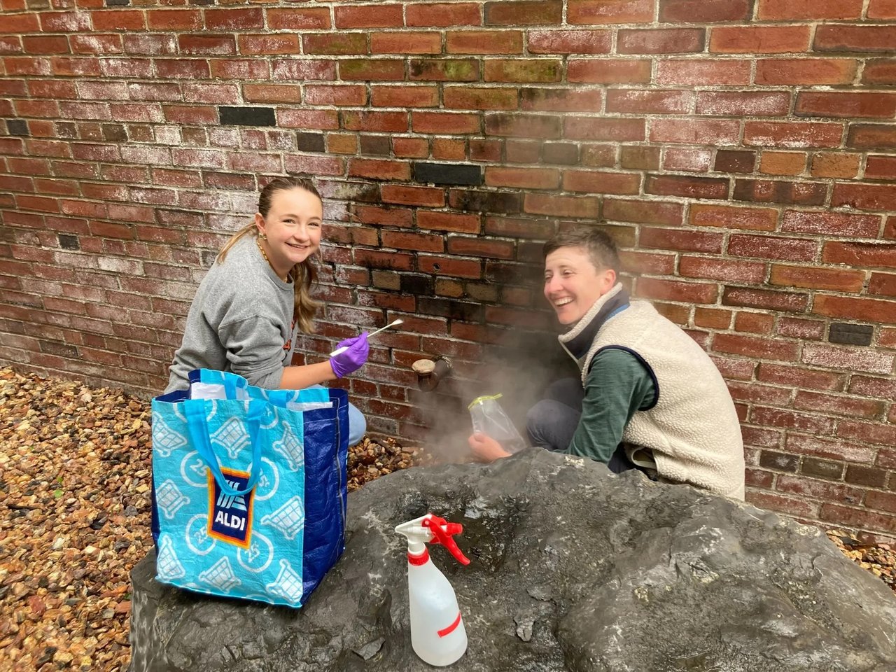 Two people sampling a steam vent.