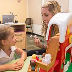 A graduate-student clinician works with a child in the Stuttering Research Lab. 