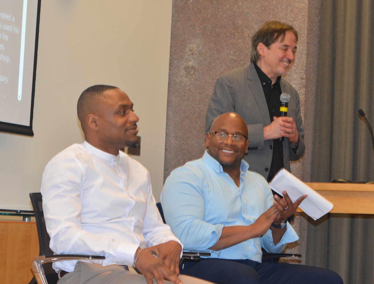 Three people addressing a room.